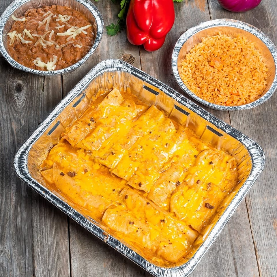 A catering tray of cheesy enchiladas, with sides of refried beans and Mexican rice.